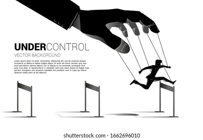 Puppet Master controlling Silhouette of businessman run and jumping across hurdles obstacle. Concept of manipulation and micromanagement