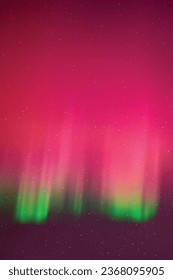 Purple aurora borealis. Blue night starry sky and pink polar lights