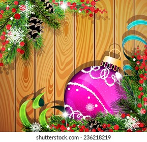 Purple Christmas ball, cones, berries and fir tree branches on wooden background