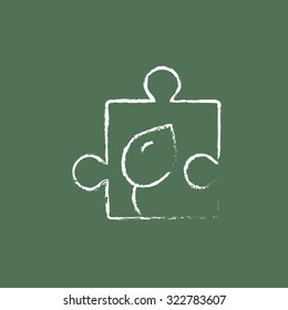 Puzzle with leaf hand drawn in chalk on a blackboard vector white icon isolated on a green background.