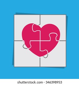 Puzzle piecing together large heart
