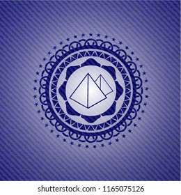 pyramids icon inside badge with denim texture
