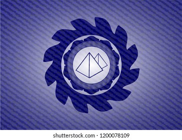 pyramids icon inside badge with denim texture