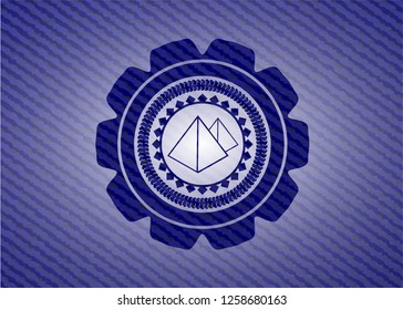 pyramids icon inside badge with denim texture
