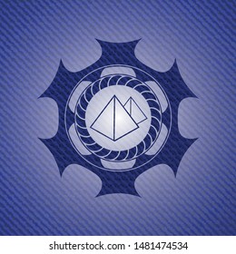 pyramids icon inside badge with denim background