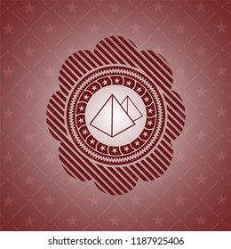 pyramids icon inside badge with red background