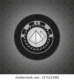 pyramids icon inside black badge. 