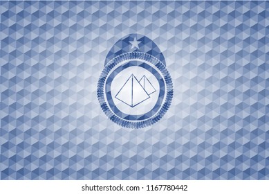 pyramids icon inside blue badge with geometric pattern.