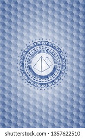 pyramids icon inside blue badge with geometric pattern.