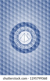 pyramids icon inside blue emblem or badge with abstract geometric polygonal pattern background.