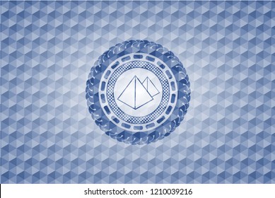 pyramids icon inside blue emblem with geometric background.