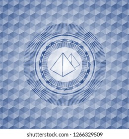 pyramids icon inside blue emblem or badge with abstract geometric polygonal pattern background.