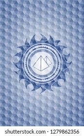 pyramids icon inside blue emblem or badge with abstract geometric pattern background.