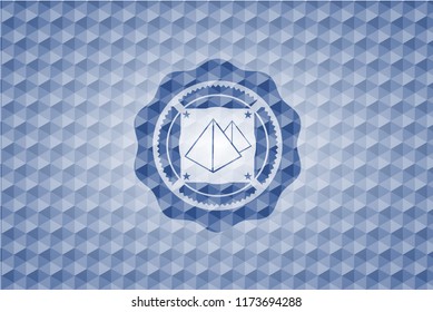 pyramids icon inside blue polygonal badge.
