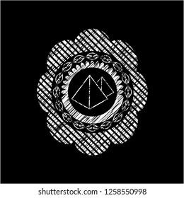 pyramids icon inside chalk emblem written on a blackboard