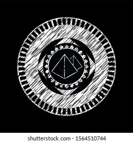 pyramids icon inside chalk emblem written on a blackboard
