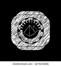 pyramids icon inside chalk emblem written on a blackboard