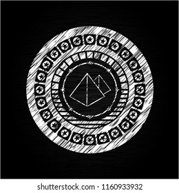 pyramids icon inside chalkboard emblem on black board