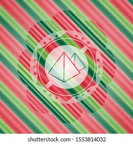 pyramids icon inside christmas colors style badge.
