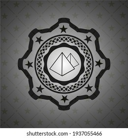 pyramids icon inside dark badge. 