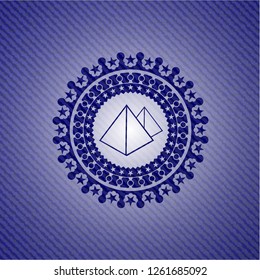 pyramids icon inside denim background