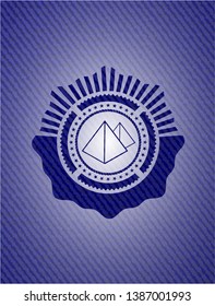 pyramids icon inside denim background