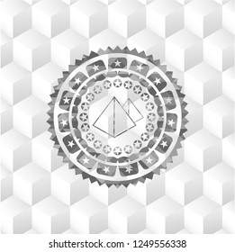 pyramids icon inside grey emblem with cube white background