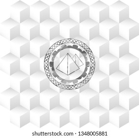 pyramids icon inside grey emblem with geometric cube white background