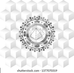 pyramids icon inside grey emblem with geometric cube white background