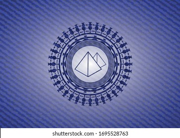 pyramids icon inside jean or denim emblem or badge background