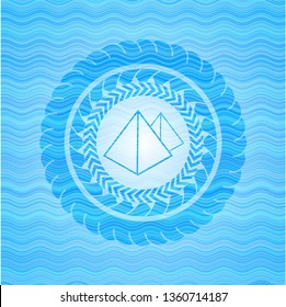 pyramids icon inside light blue water wave style badge.