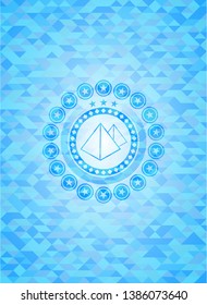 pyramids icon inside light blue emblem with mosaic ecological style background