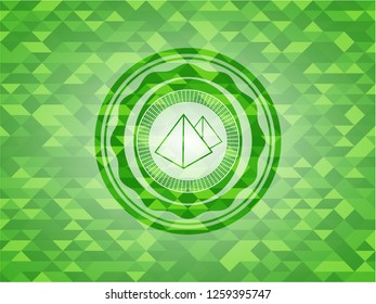 pyramids icon inside realistic green emblem. Mosaic background