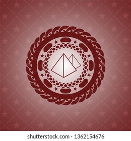 pyramids icon inside red emblem