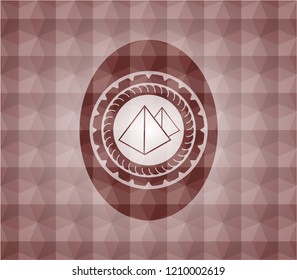 pyramids icon inside red seamless badge with geometric pattern.