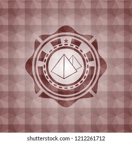 pyramids icon inside red seamless emblem with geometric background.