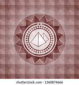pyramids icon inside red seamless badge with geometric pattern background.