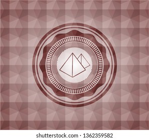pyramids icon inside red seamless geometric badge.