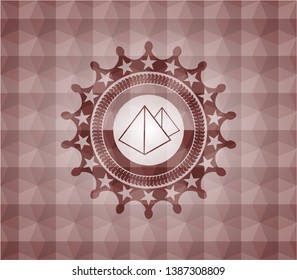 pyramids icon inside red seamless badge with geometric pattern background.