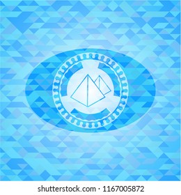 pyramids icon inside sky blue emblem. Mosaic background