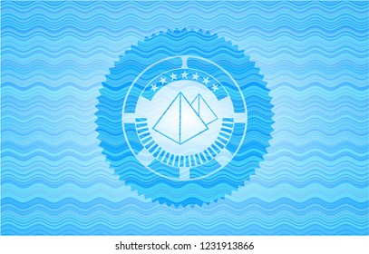 pyramids icon inside sky blue water badge background.