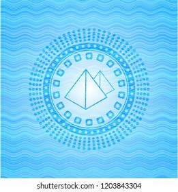 pyramids icon inside water wave representation style badge.