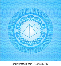 pyramids icon inside water wave representation emblem background.