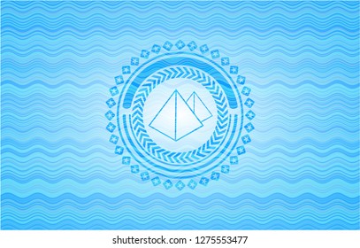 pyramids icon inside water wave concept style emblem.