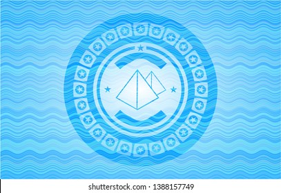 pyramids icon inside water wave concept emblem background.