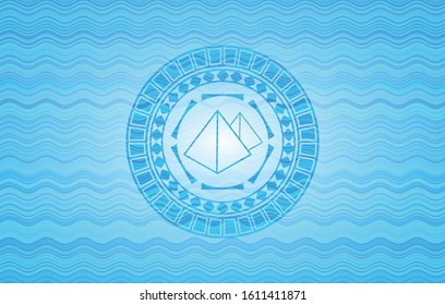 pyramids icon inside water wave concept badge background.