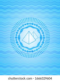 pyramids icon inside water wave concept badge background.