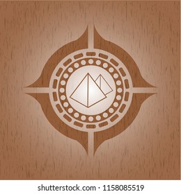 pyramids icon inside wooden emblem