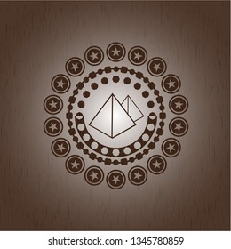 pyramids icon inside wooden emblem. Retro