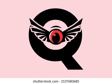 Q initial letter with red eye wings design